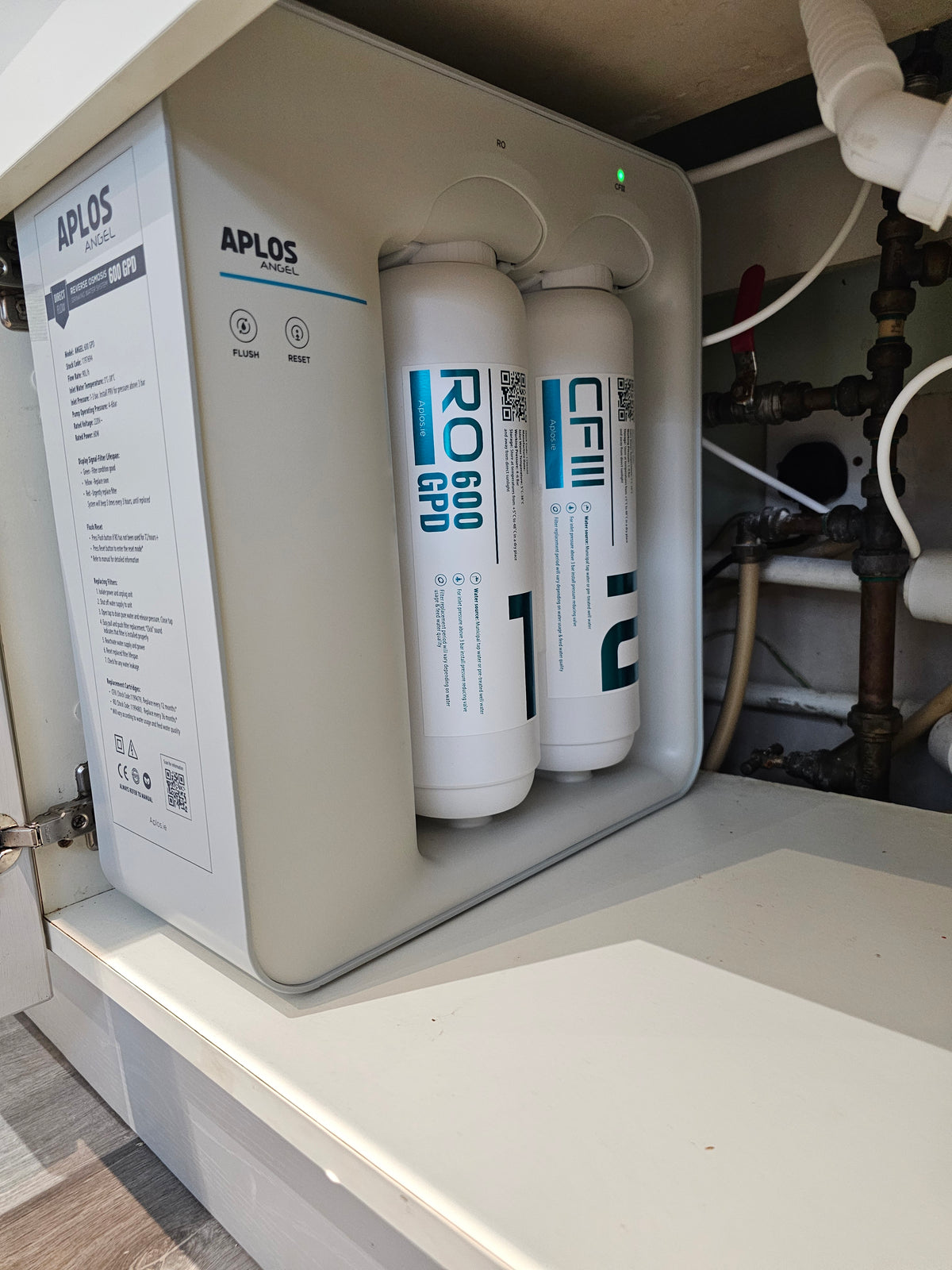 A water system fitted under a kitchen sink